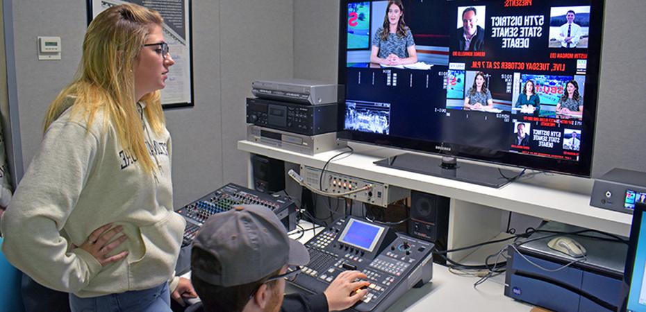 Students watching monitors while producing a news show for SBU-TV